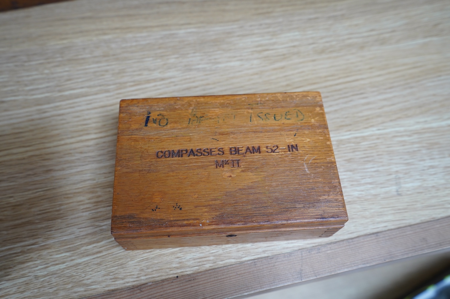 A early 20th century boxed 52 inch, draughtsman’s beam compasses, Mk.II, together with two oak boxes of fittings, all three boxes stamped with; ‘ COMPASSES BEAM 52-IN Mk.II’, and an early 20th century German leather case